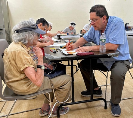 Raul Manzano and people drawing at tables